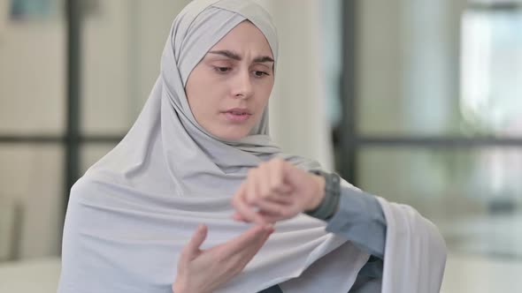 Young Arab Woman Checking Watch Waiting