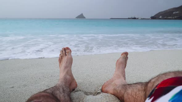 Mans Feet on Sandy Beach