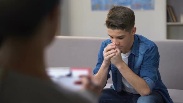 Aggressive Teenager Talking to Psychologist, Visiting Rehab Session, Awkward Age