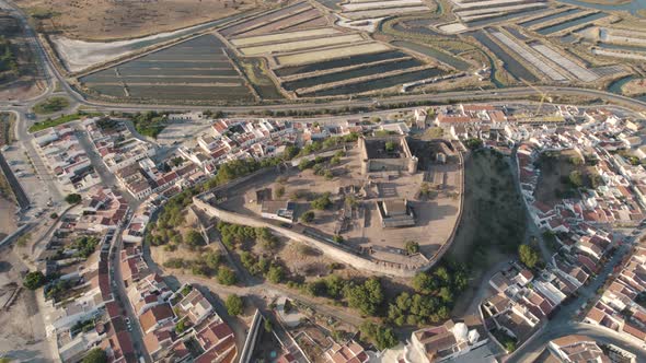 Aerial birds eye view of Castelo de Castro Marim Castle, village settlements and salt pans.