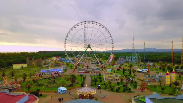 Top view of amusement park with Ferris wheel and roller coaster