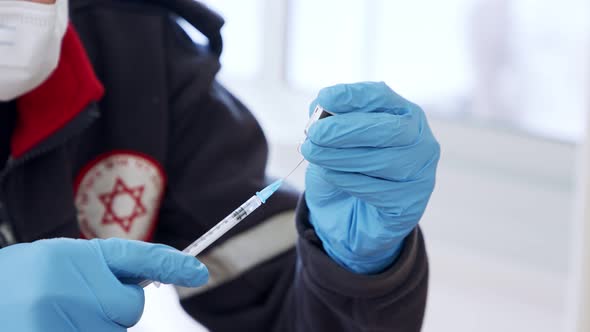 Paramedic giving people the COVID-19 vaccine injection during the vaccination operation