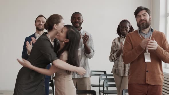 Diverse Colleagues Clapping Hands and Hugging