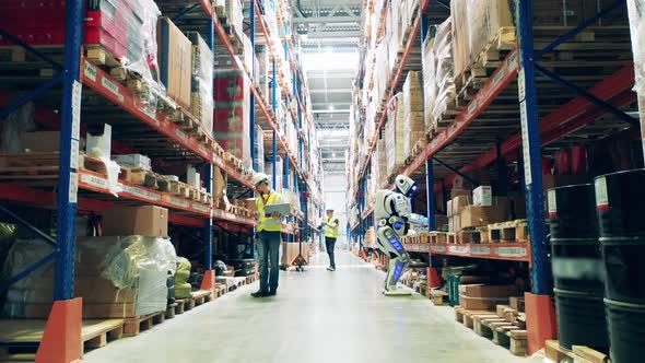 Warehouse with Employees and a Cyborg Working Together