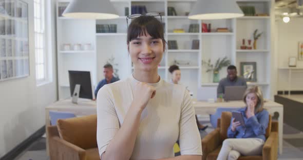 Young woman smiling to camera at the office