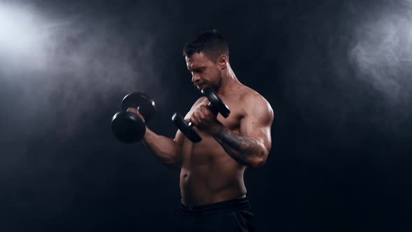 Fit and sporty bodybuilder over black background.