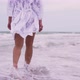 Girl Walks on the Beach on the Background of the Sea - VideoHive Item for Sale