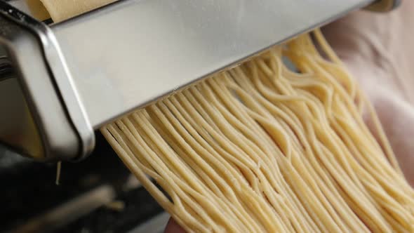 Manually processed Italian spaghetti food 4K 2160p 30fps UltraHD footage - Dough made  cylindrical s