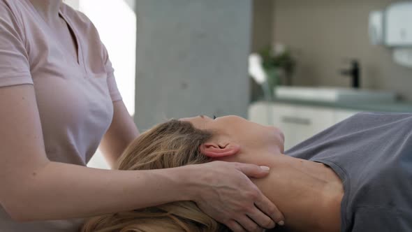 Close up female physical therapist massaging her patient. Shot with RED helium camera in 8K.