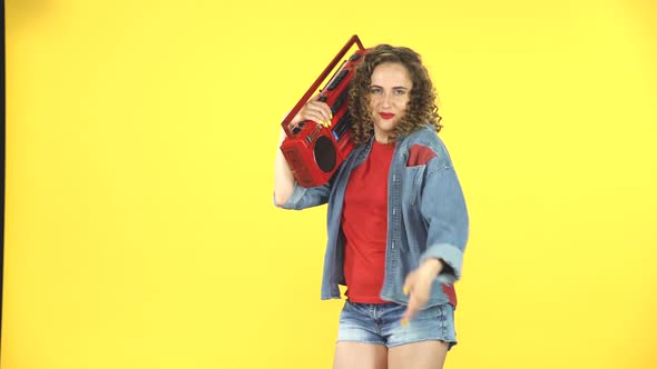 Young Woman Having Fun Dancing with the Retro Style Boombox and Calling To Herself