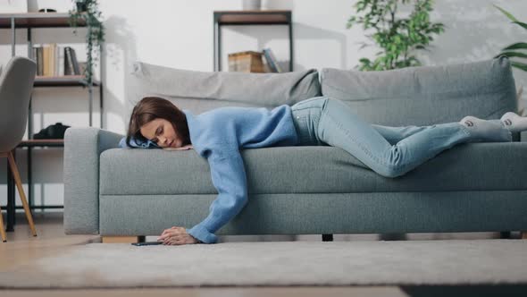 Bored Woman Using Smartphone on Couch