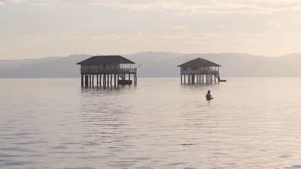 Scenic View of Calm Ocean and Bungalow Houses in a Tropical Island