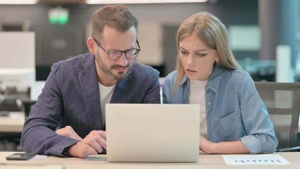 Middle Aged Man and Young Woman Having Loss While Using Laptop