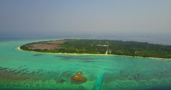 Daytime aerial tourism shot of a summer white paradise sand beach and aqua blue ocean background in 