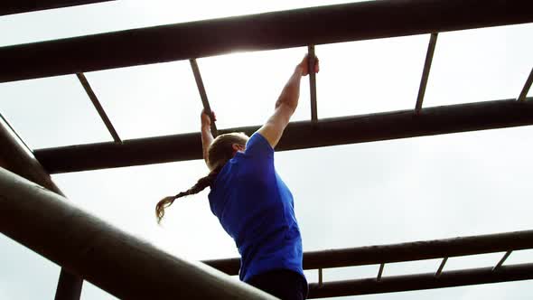 Fit woman climbing monkey bars 4k