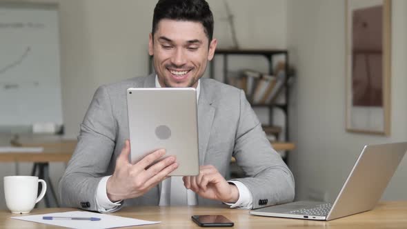 Video Chat on Tablet By Businessman
