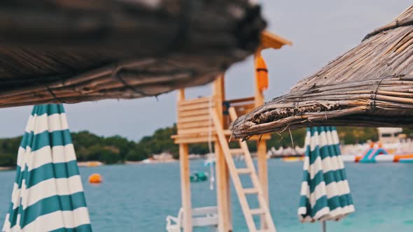 Straw Beach Umbrellas on Background of Blue Sea in Low Season Albania Ksamil