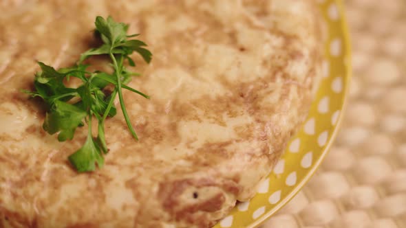 Spanish Omelette Garnished With Cilantro Leaves. - close up, orbit shot