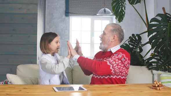 Grandpa and Granddaughter Are Spending Good Time Together