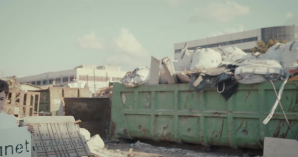 Save the planet. kids holding signs standing in a huge junkyard