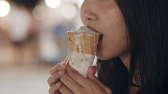 Asian young woman travel in Bangkok, Thailand, happy walking and eat ice cream at The Khao San Road.