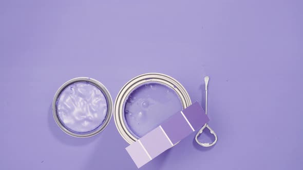 Close up of metal paint can with purple paint and paint swatch.