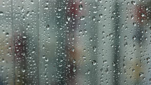Raindrops run down the window pane on a rainy day