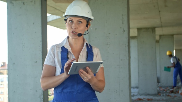 Female construction engineer reading plans using digital