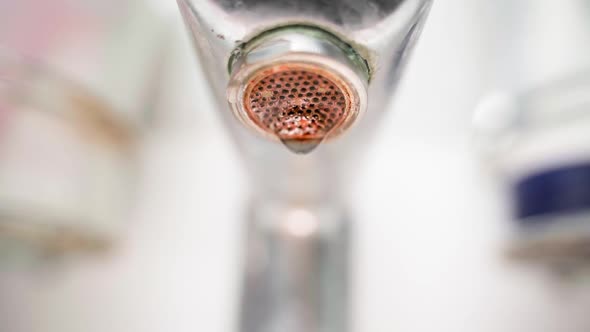 Falling Water Drop in Slow Motion From a Sink Faucet Closeup