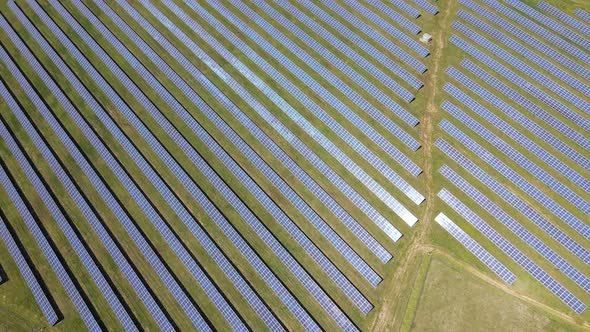 Aerial View of Big Sustainable Electric Power Plant with Many Rows of Solar Photovoltaic Panels for