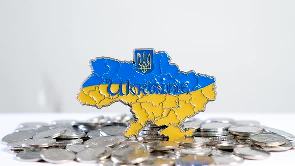 The Outlines of the Country of Ukraine and the Coins That Fall From Above