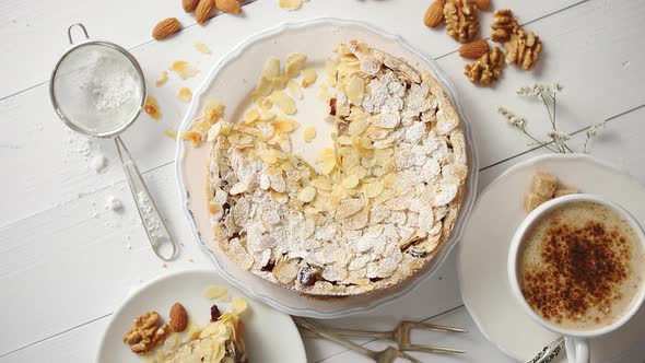 Whole Delicious Apple Cake with Almonds Served on Wooden Table