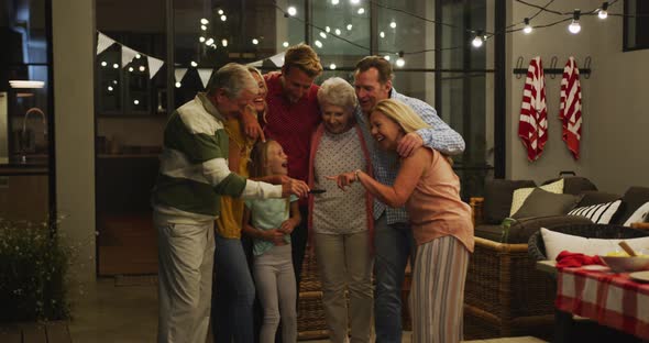 Caucasian family spending time and laughing together, taking photo in the garden