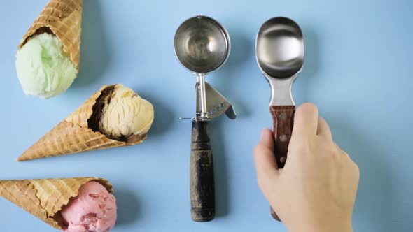 Waffle ice cream cones with scoops of ice cream on a blue background.