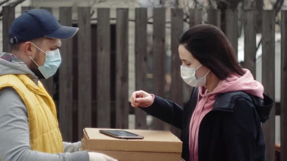 Postman or Delivery Man Carry Small Box Deliver to Young Woman Customer at Home