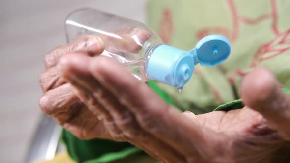 Close Up of Senior Women Hand Using Sanitizer Gel for Preventing Virus