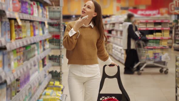 Woman is Shopping at the Supermarket