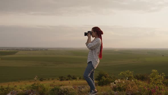 Girl Start to Take Some Photos on a Fields