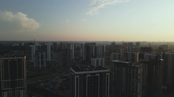 City block construction site. Multi-storey buildings. City landscape at sunrise. Aerial photography.