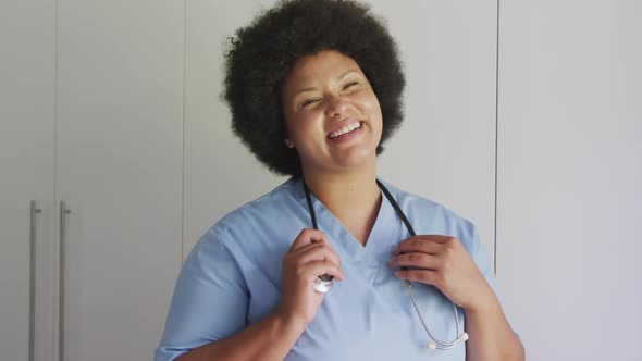 Video of happy plus size african american female doctor looking at camera