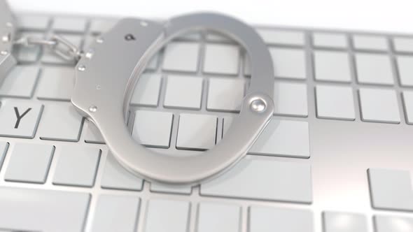 Handcuffs on Keyboard with PIRACY Text on Keys alt