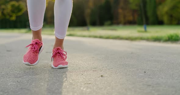 Handheld view of woman’s legs starting up her jogging training