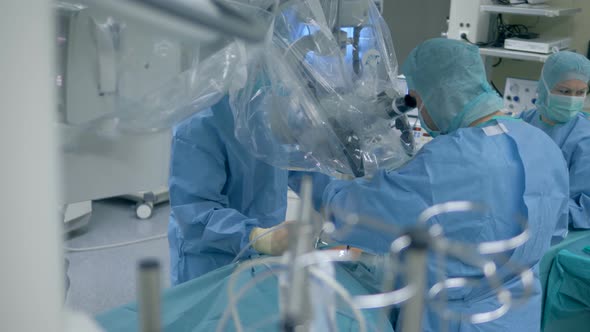 Many Doctors in a Surgery Room. Doctors and Nurses Perform a Surgery in a Room