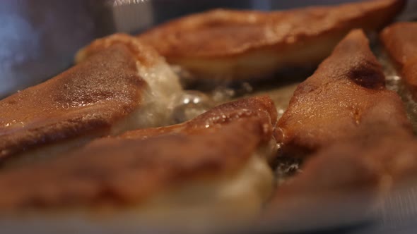 Close-up dough made  Pirozhki arranged in frying pan 3840X2160 UltraHD footage - Sunflower oil and f