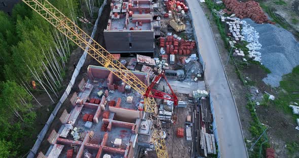 Construction site of low-rise brick houses in summer. Aerial view