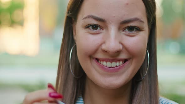 Relaxed Smiling Satisfied Woman with Red Cup of Coffee Standing on the Street End Enjoying a Sunny