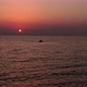 Drone flying around the lonely boat in the sea with a fishing man at sunrise. Amazing rising sun - VideoHive Item for Sale