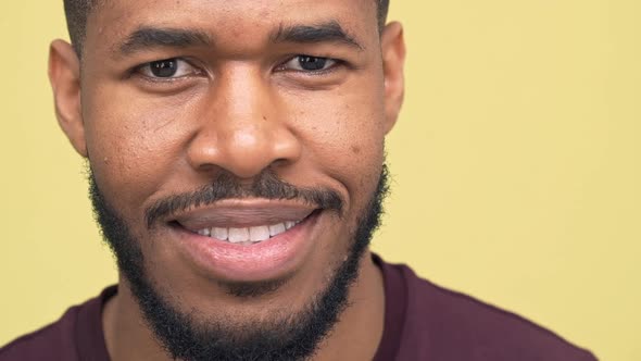 Picture of Darkskinned Bearded Guy Expressing Happiness Smiling Nodding Positively Over Yellow