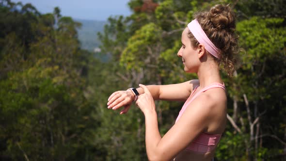 Sport Hiker Woman Using Smartwatch While Hiking In Forest