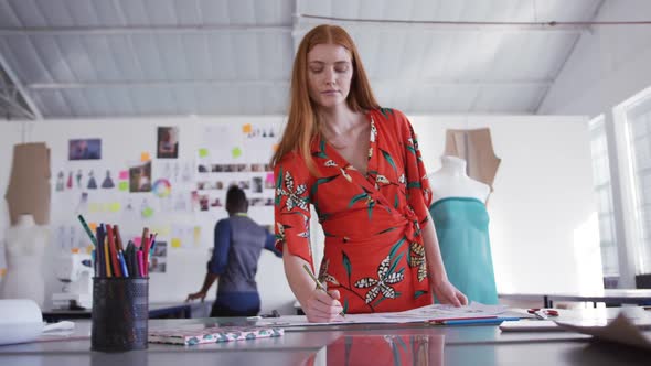 Caucasian woman working in fashion office